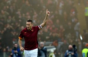 Roma's forward Francesco Totti celebrates after scoring during the Italian Serie A football match AS Roma vs Lazio on January 11, 2015 at the Olympic Stadium in Rome. AFP PHOTO / TIZIANA FABI (Photo credit should read TIZIANA FABI/AFP/Getty Images)