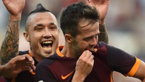 Roma's midfielder from Bosnia-Herzegovina Miralem Pjanic (R) celebrates with Roma's midfielder from Belgium Radja Nainggolan after scoring during the Italian Serie A football match AS Roma vs Juventus on August 30, 2015 at the Olympic stadium in Rome. AFP PHOTO / FILIPPO MONTEFORTE (Photo credit should read FILIPPO MONTEFORTE/AFP/Getty Images)