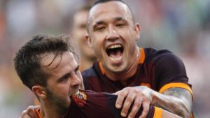 Roma's Miralem Pjanic, left, celebrates with teammate Radja Nainggolan after scoring on a free kick during a Serie A soccer match between Roma and Juventus, at Rome's Olympic stadium, Sunday, Aug. 30, 2015. (AP Photo/Riccardo De Luca)